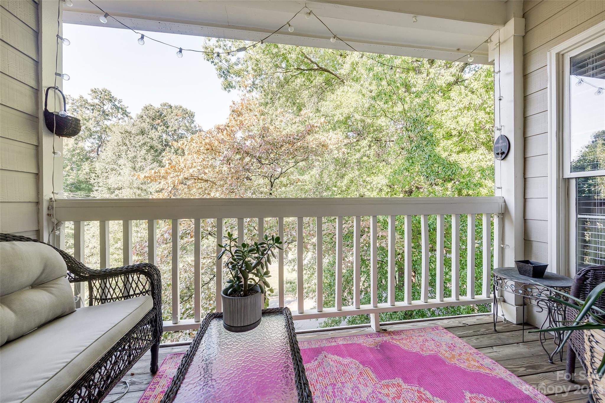 301 Queens Road, Unit 304 Charlotte, NC 28204 - Photo 24 of 26 a living room with furniture and a floor to ceiling window