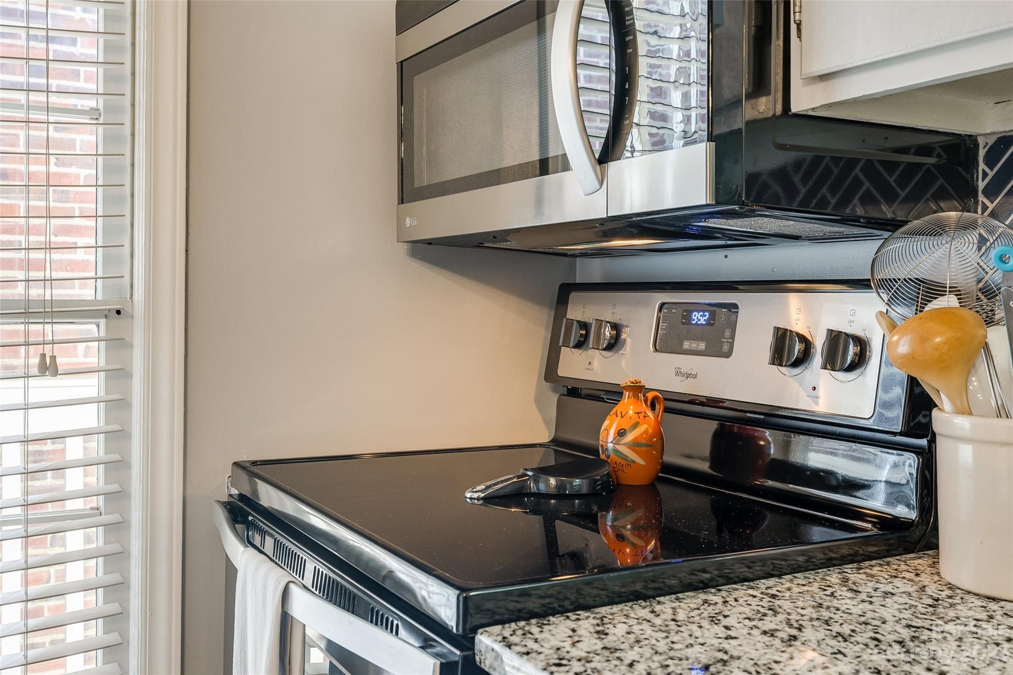 301 Queens Road, Unit 304 Charlotte, NC 28204 - Photo 7 of 26 a stove top oven sitting inside of a kitchen
