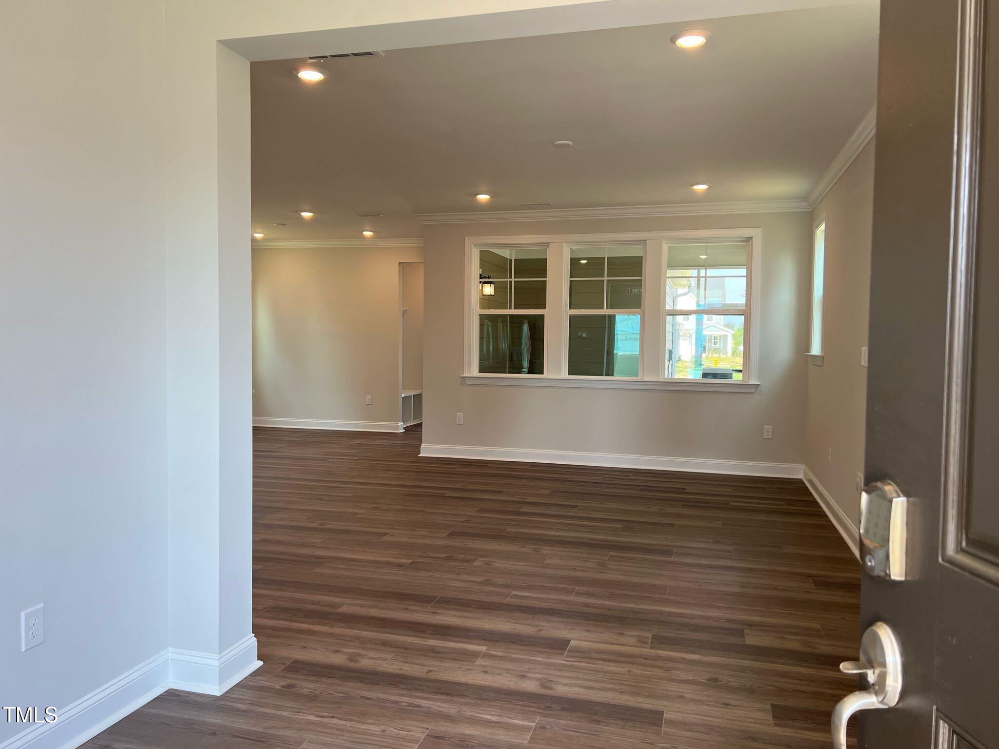 409 Cresting Wave Drive Wake Forest, NC 27587 - Photo 6 of 31 an empty room with wooden floor and windows