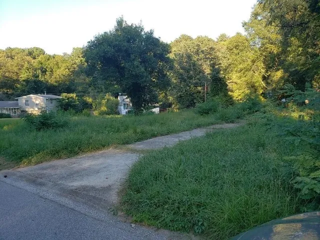 a view of a street with a trees in the background