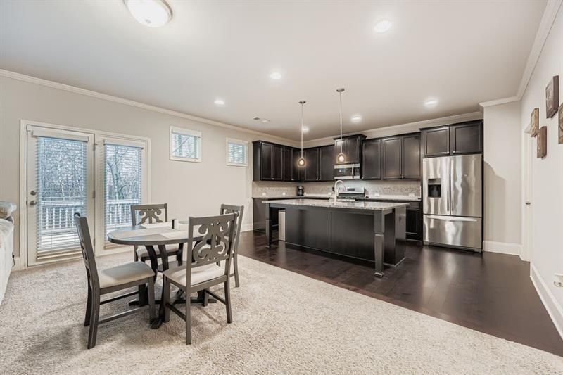 122 Prospect Lane Dallas, GA 30157 - Photo 12 of 34 a kitchen with refrigerator a sink and chairs