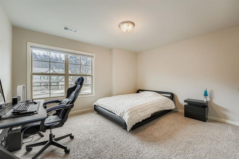122 Prospect Lane Dallas, GA 30157 - Photo 18 of 34 a bedroom with a bed and a desk