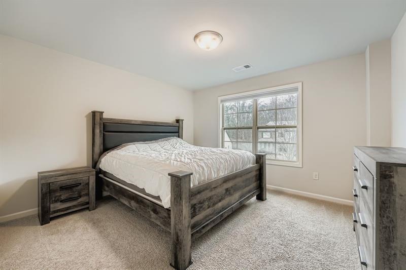 122 Prospect Lane Dallas, GA 30157 - Photo 19 of 34 a bed sitting in a bedroom next to a window