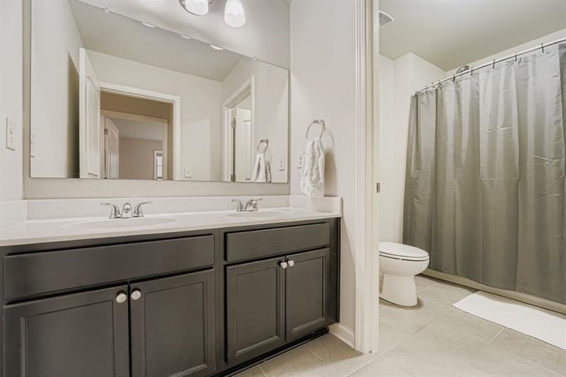 122 Prospect Lane Dallas, GA 30157 - Photo 20 of 34 a bathroom with a double vanity sink toilet and a mirror
