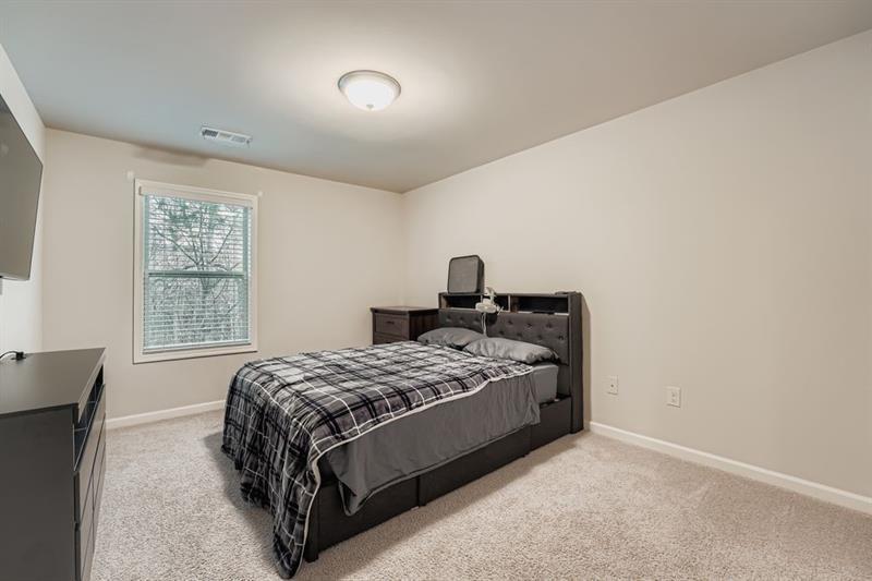 122 Prospect Lane Dallas, GA 30157 - Photo 21 of 34 a bed sitting in a bedroom next to a window
