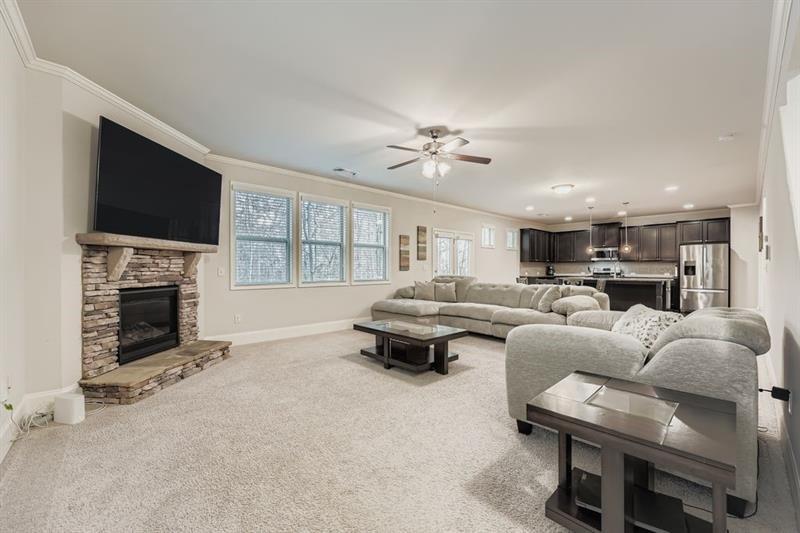 122 Prospect Lane Dallas, GA 30157 - Photo 6 of 34 a living room with furniture a fireplace and a flat screen tv