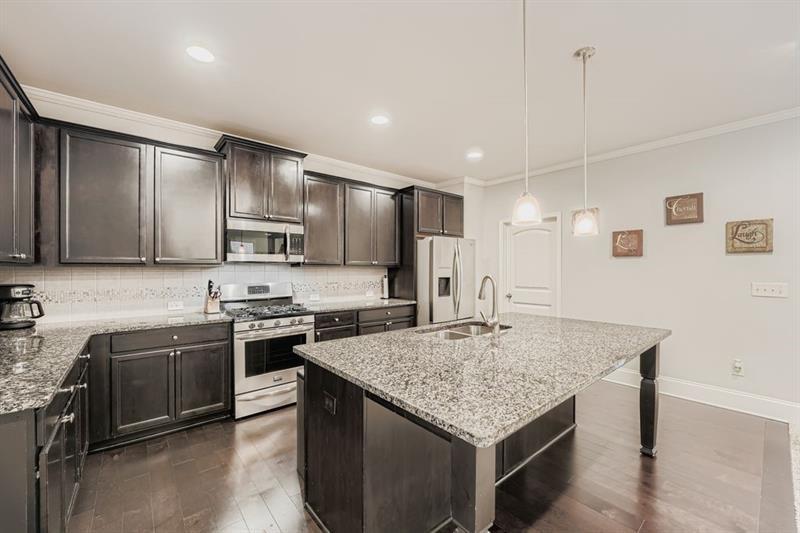 122 Prospect Lane Dallas, GA 30157 - Photo 9 of 34 a kitchen with stainless steel appliances granite countertop a kitchen island a stove and a sink