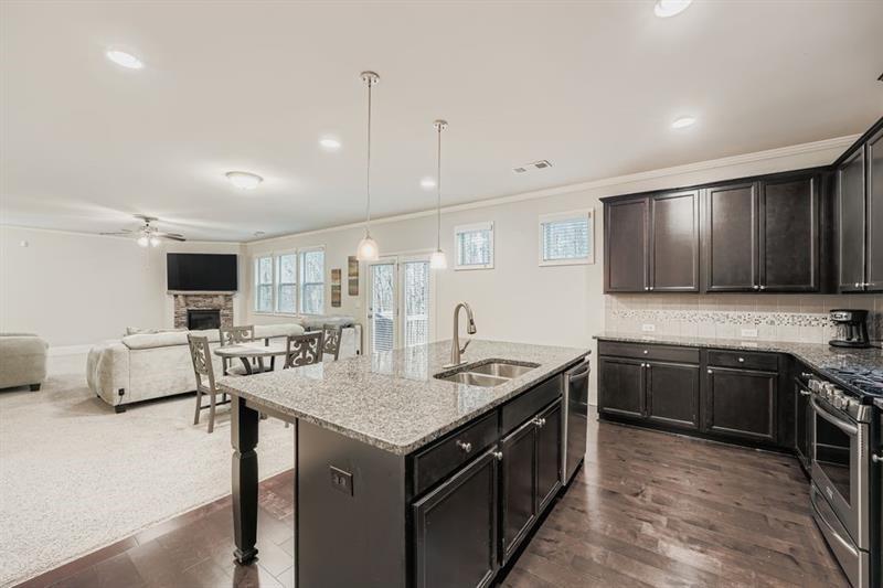 122 Prospect Lane Dallas, GA 30157 - Photo 10 of 34 a kitchen with granite countertop a sink stove and cabinets