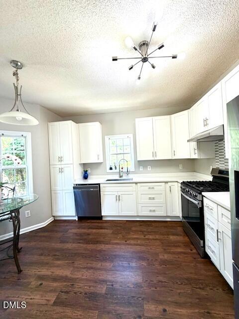 6016 River Lake Circle Raleigh, NC 27604 - Photo 10 of 20 a kitchen with stainless steel appliances white cabinets and wooden floor