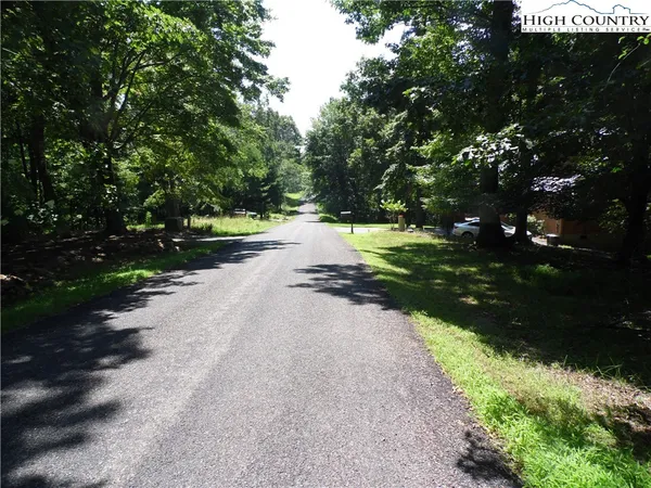 a view of a street with a yard