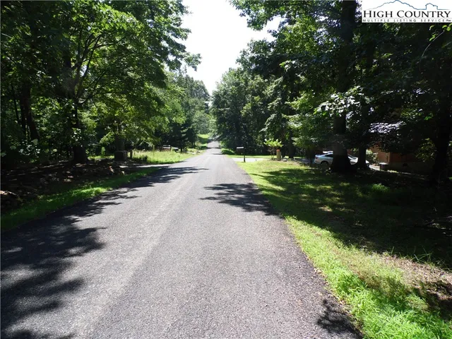 a view of a street with a yard