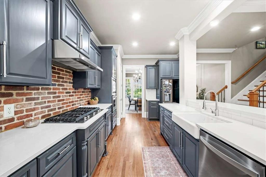 3440 Rialto Place Alpharetta, GA 30022 - Photo 12 of 66 a kitchen with stainless steel appliances a sink stove and cabinets