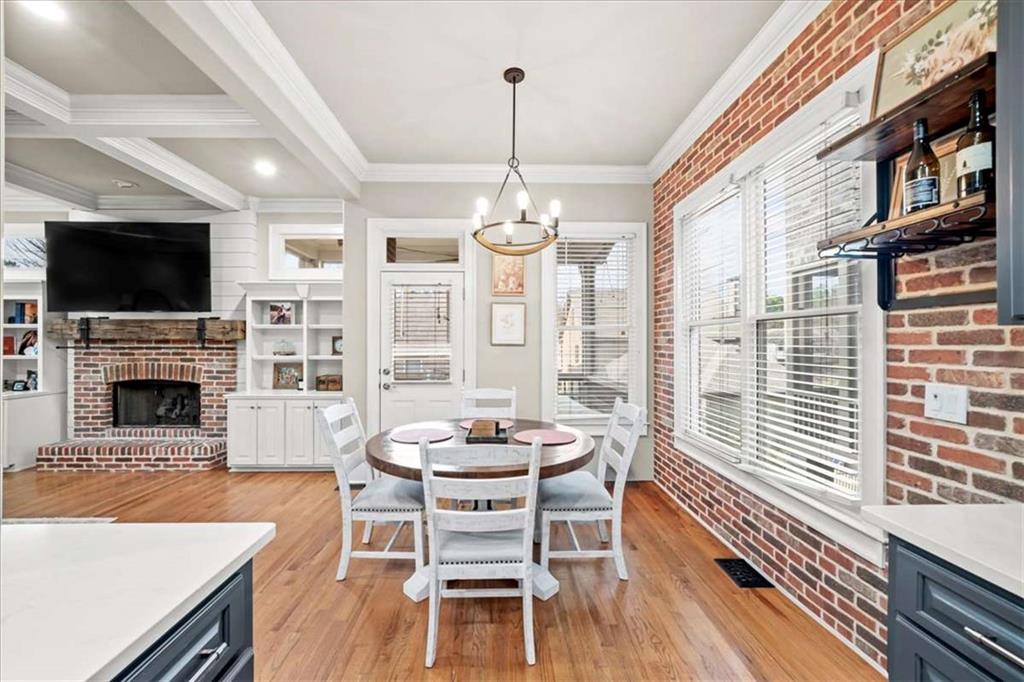 3440 Rialto Place Alpharetta, GA 30022 - Photo 17 of 66 a dining room with furniture a flat screen tv and a fireplace