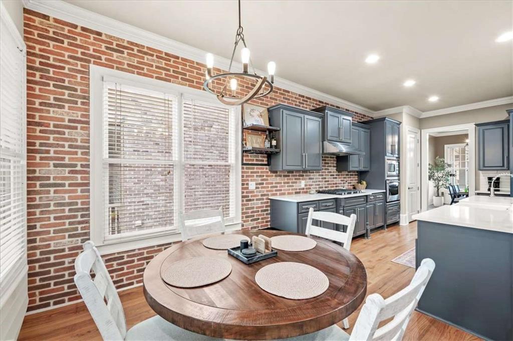 3440 Rialto Place Alpharetta, GA 30022 - Photo 19 of 66 a kitchen with sink refrigerator dining table and chairs