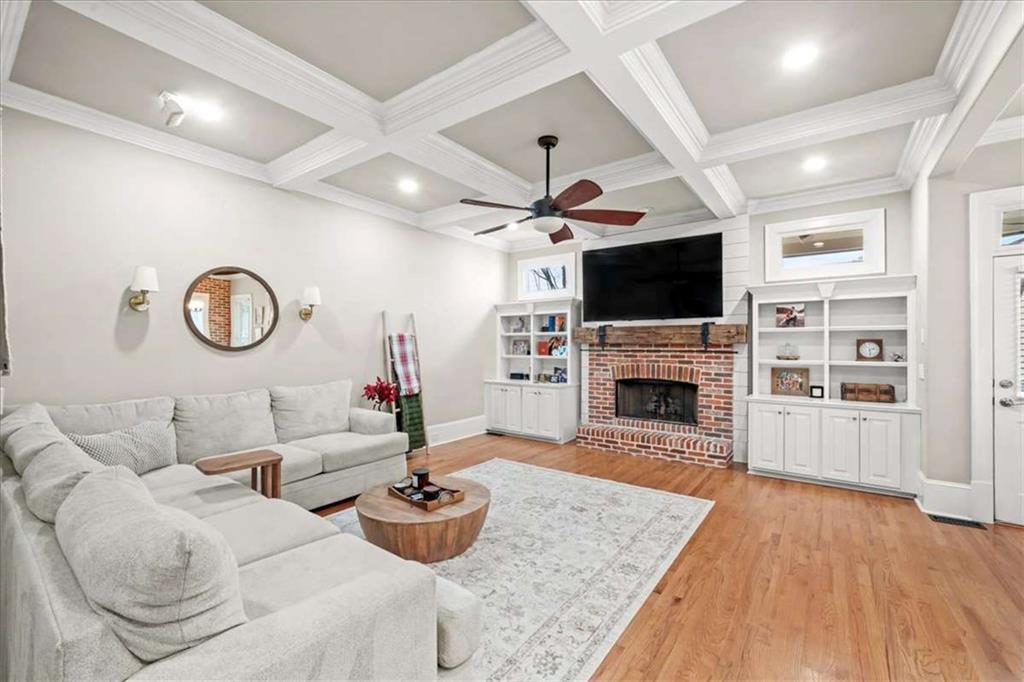 3440 Rialto Place Alpharetta, GA 30022 - Photo 23 of 66 a living room with furniture a fireplace and a flat screen tv