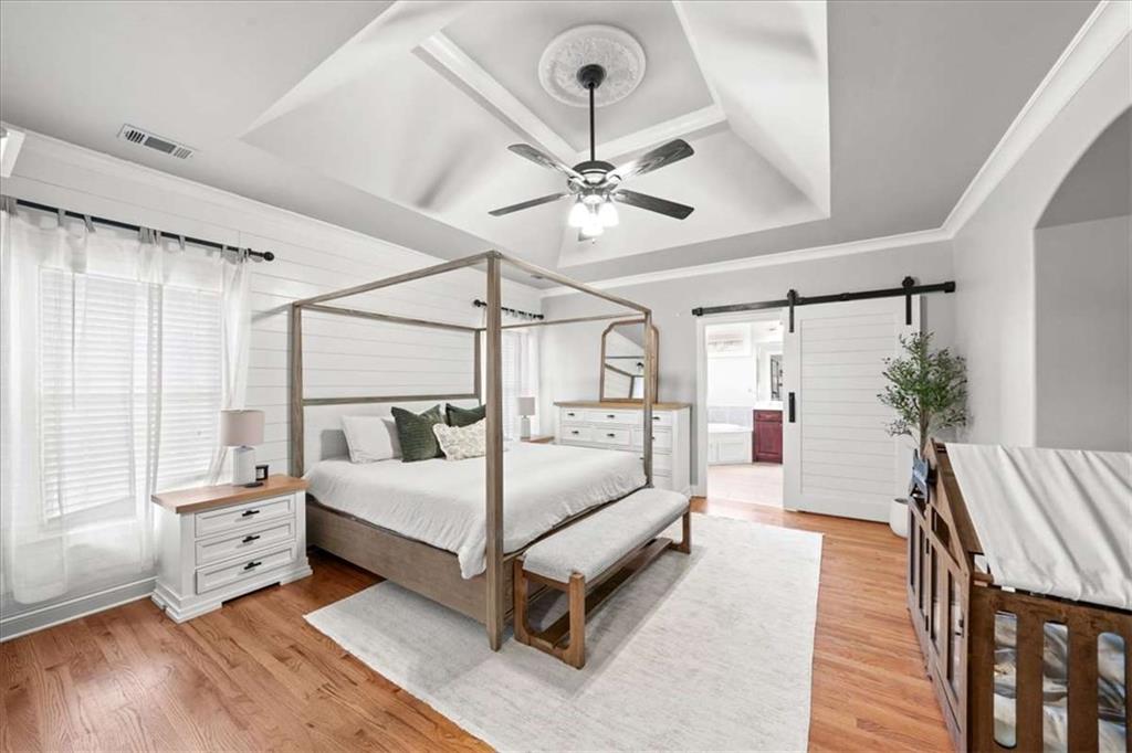 3440 Rialto Place Alpharetta, GA 30022 - Photo 29 of 66 a bedroom with a bed and a chandelier