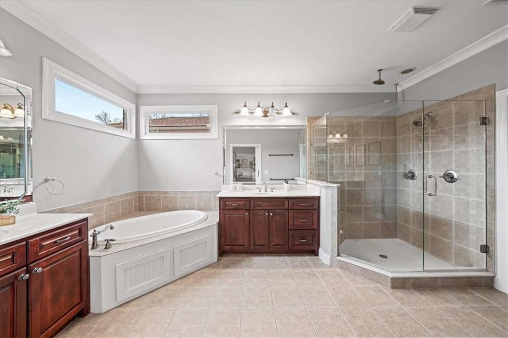 3440 Rialto Place Alpharetta, GA 30022 - Photo 34 of 66 a bathroom with a tub sink mirror and a shower