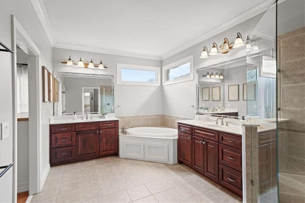 3440 Rialto Place Alpharetta, GA 30022 - Photo 35 of 66 a bathroom with a sink double vanity tub and a mirror