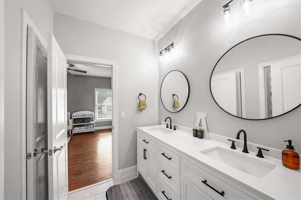 3440 Rialto Place Alpharetta, GA 30022 - Photo 38 of 66 a en suite bathroom with a double vanity sink and a mirror