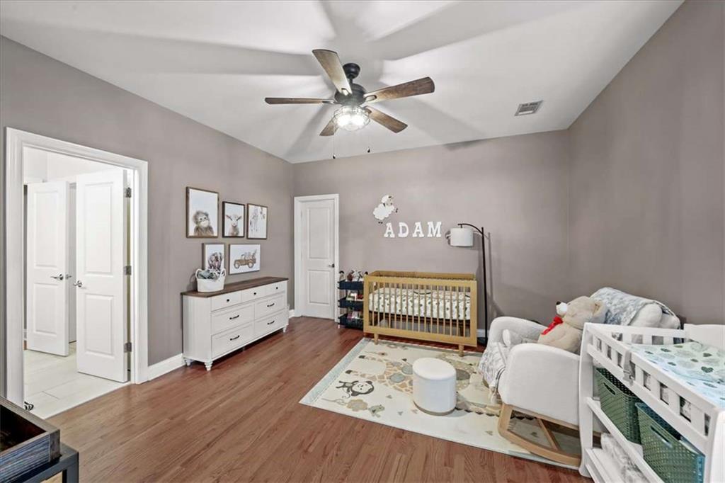 3440 Rialto Place Alpharetta, GA 30022 - Photo 40 of 66 a bedroom with furniture and a wooden floor