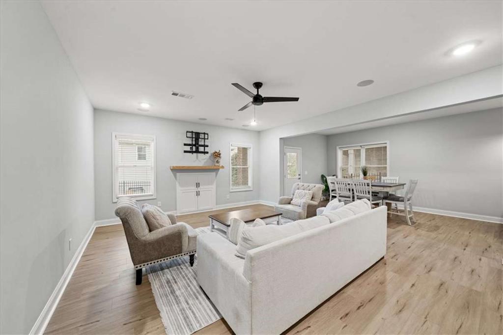 3440 Rialto Place Alpharetta, GA 30022 - Photo 46 of 66 a living room with furniture and a wooden floor