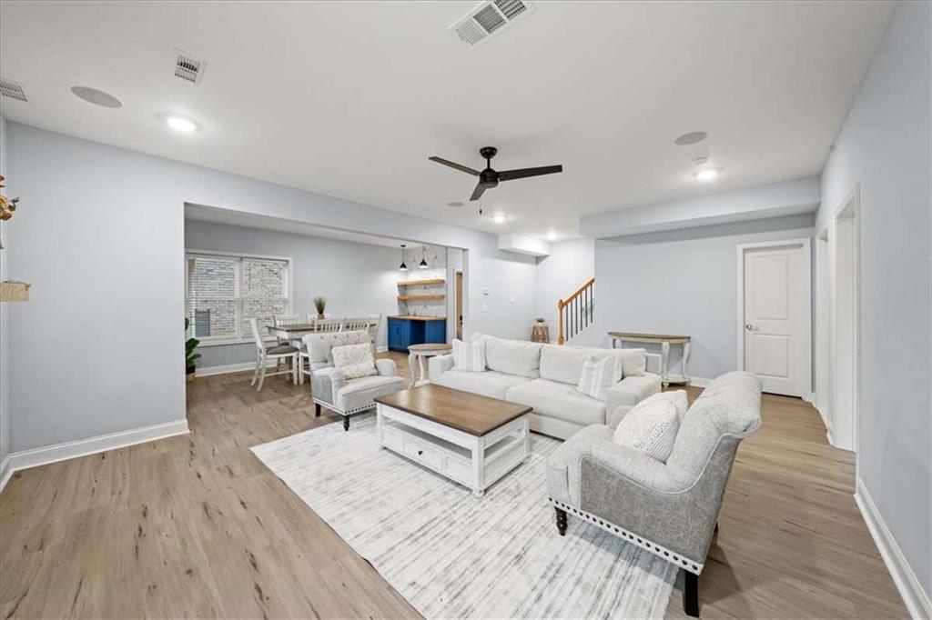 3440 Rialto Place Alpharetta, GA 30022 - Photo 47 of 66 a living room with furniture and a wooden floor