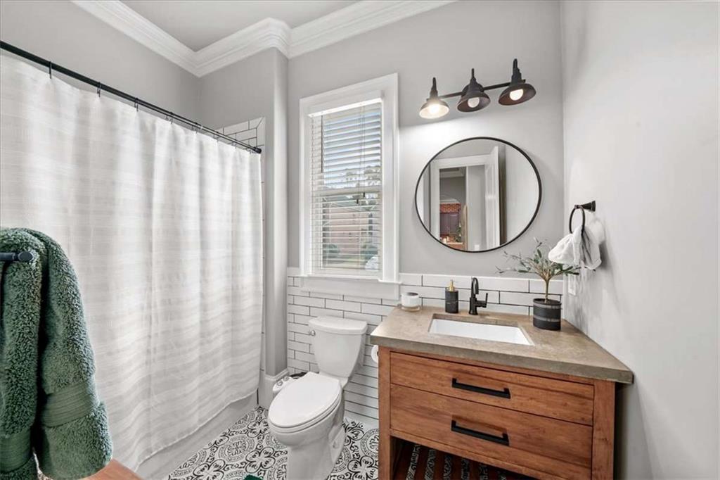 3440 Rialto Place Alpharetta, GA 30022 - Photo 49 of 66 a bathroom with a sink vanity mirror and toilet