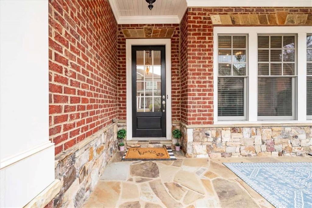 3440 Rialto Place Alpharetta, GA 30022 - Photo 7 of 66 a front view of a house with a yard