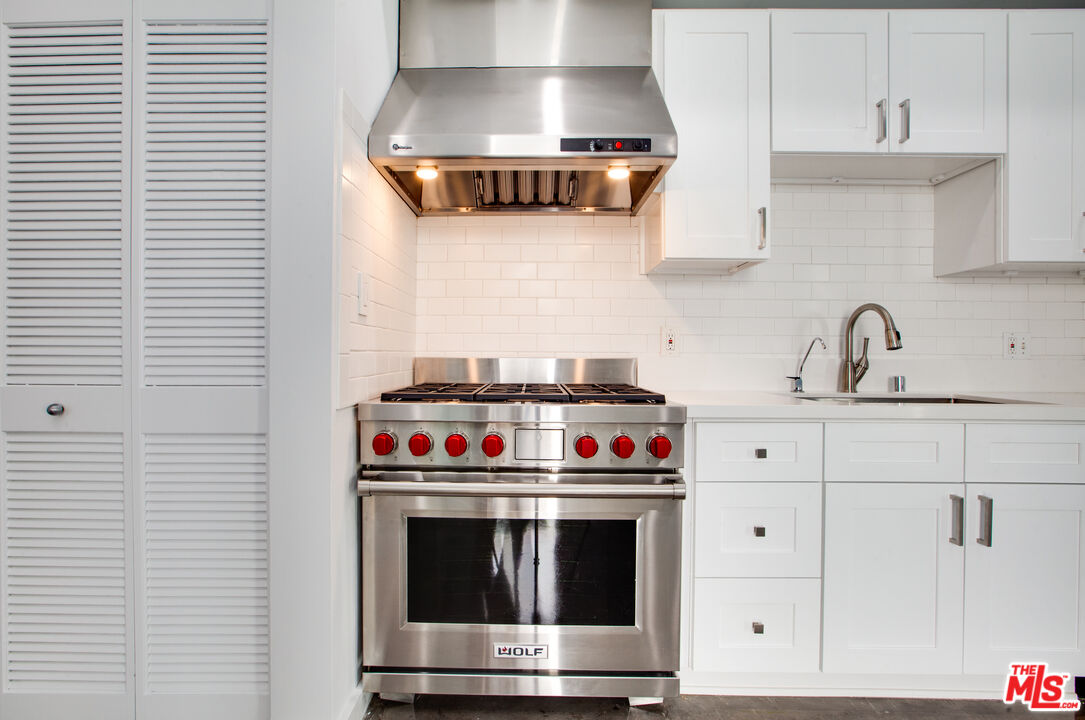 1358 4th Street, Unit PHE Santa Monica, CA 90401 - Photo 9 of 23 a kitchen with stainless steel appliances a stove and a sink