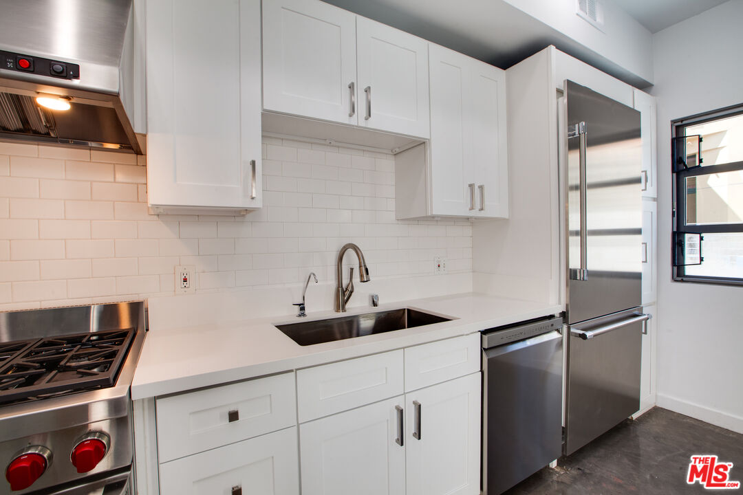1358 4th Street, Unit PHE Santa Monica, CA 90401 - Photo 10 of 23 a kitchen with cabinets and appliances