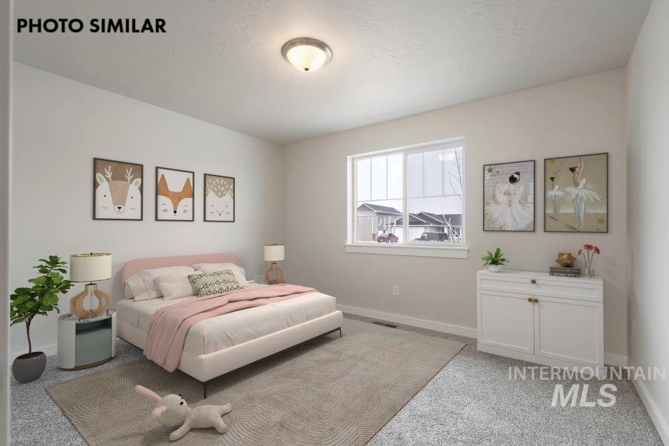 1645 Haystack Emmett, ID 83617 - Photo 21 of 33 Bedroom featuring light gray walls, white trim, and a flush-mount ceiling light