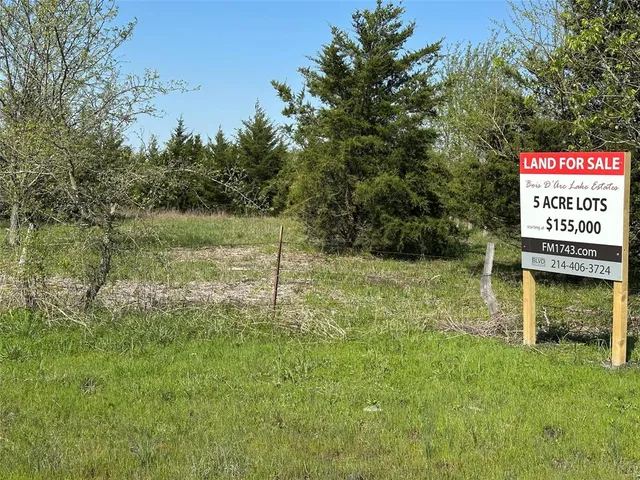 a view of a lush green outdoor space with a lake view