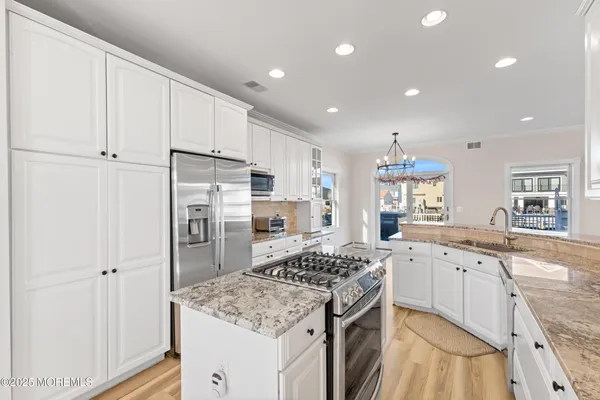 a kitchen with a sink stove and refrigerator