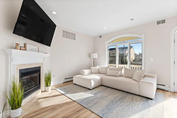 a living room with furniture a fireplace and a flat screen tv