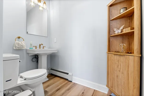 a bathroom with a toilet a sink and mirror