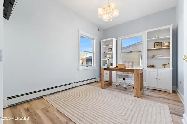 a view of a bedroom with furniture and a window