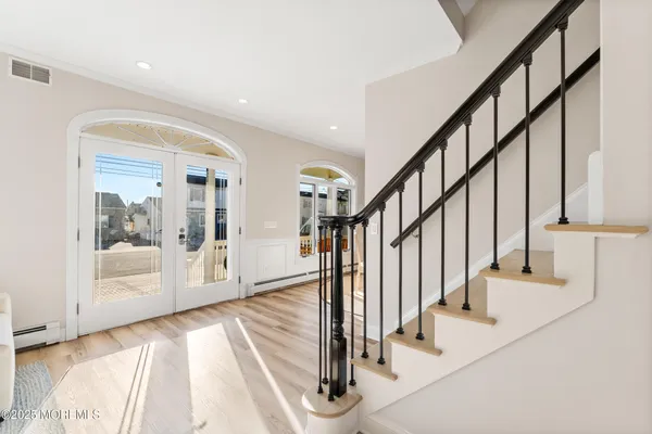 a spacious bedroom with a bed and a chandelier