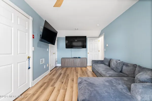 a room with pool table and wooden floor