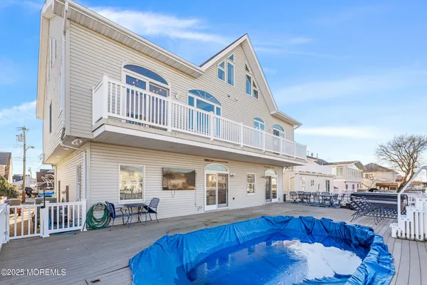 an aerial view of residential houses with outdoor space and swimming pool