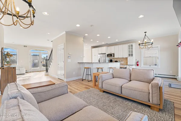a living room with furniture and kitchen view