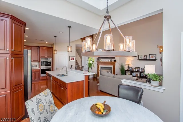 a kitchen with stainless steel appliances granite countertop a sink a stove and a refrigerator