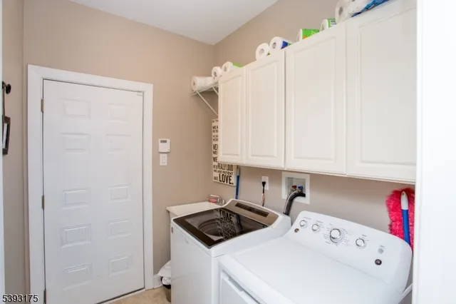 a view of a storage and utility room with washer and dryer