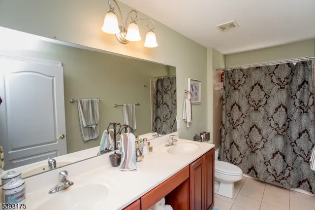 a bathroom with a sink double vanity and a mirror