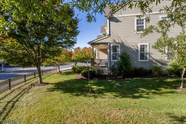 a view of a house with a yard and sitting area