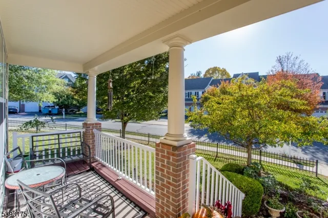 a view of a porch with furniture and wooden floor