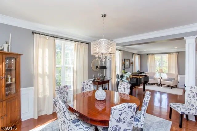 a dining room with furniture and wooden floor