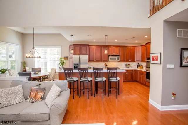 a living room with lots of furniture and kitchen view