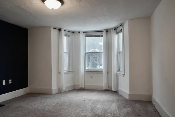 a view of an empty room and closet area