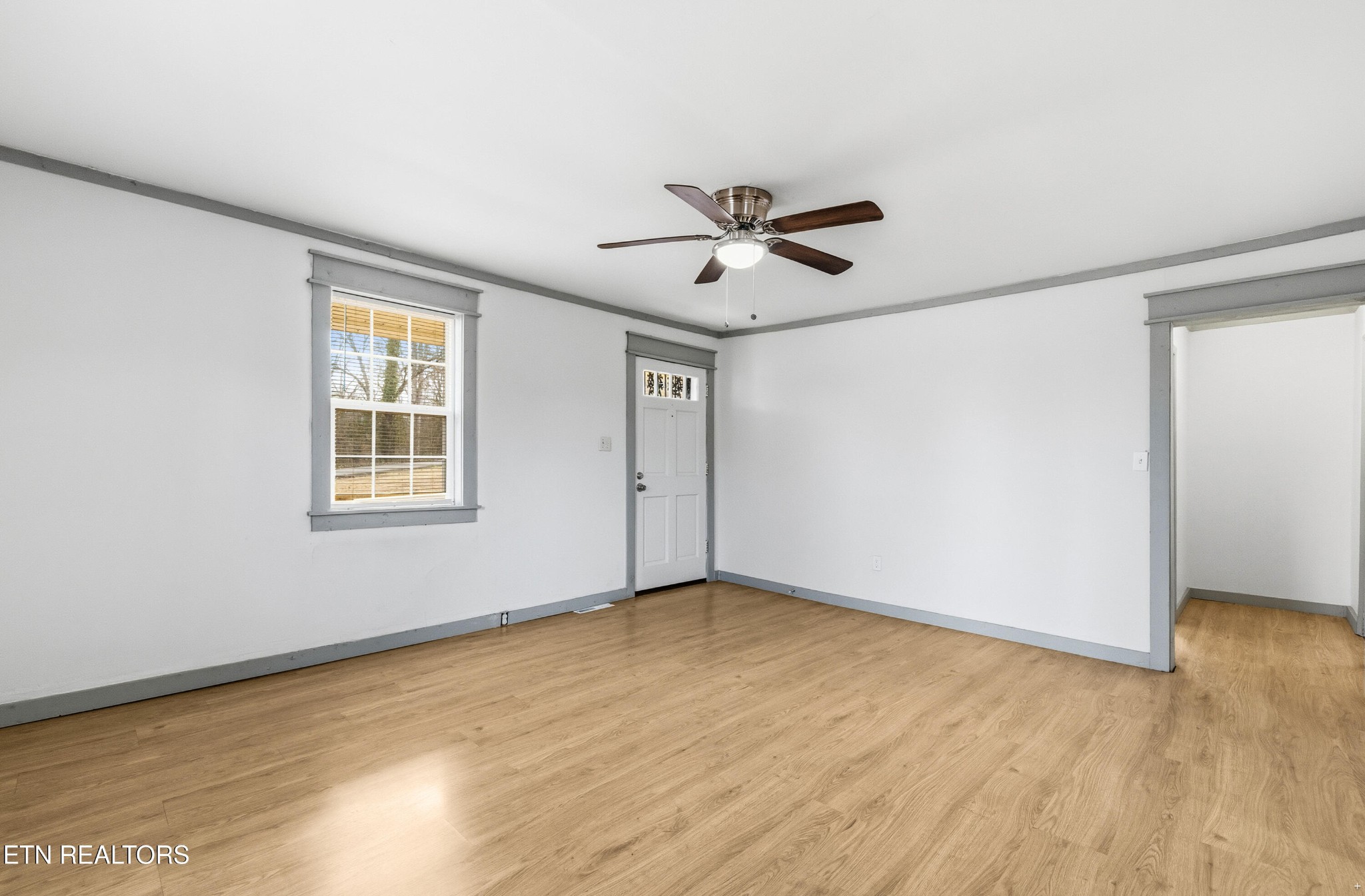 2438 Southside Road Knoxville, TN 37920 - Photo 12 of 21 a view of an empty room with wooden floor and a window