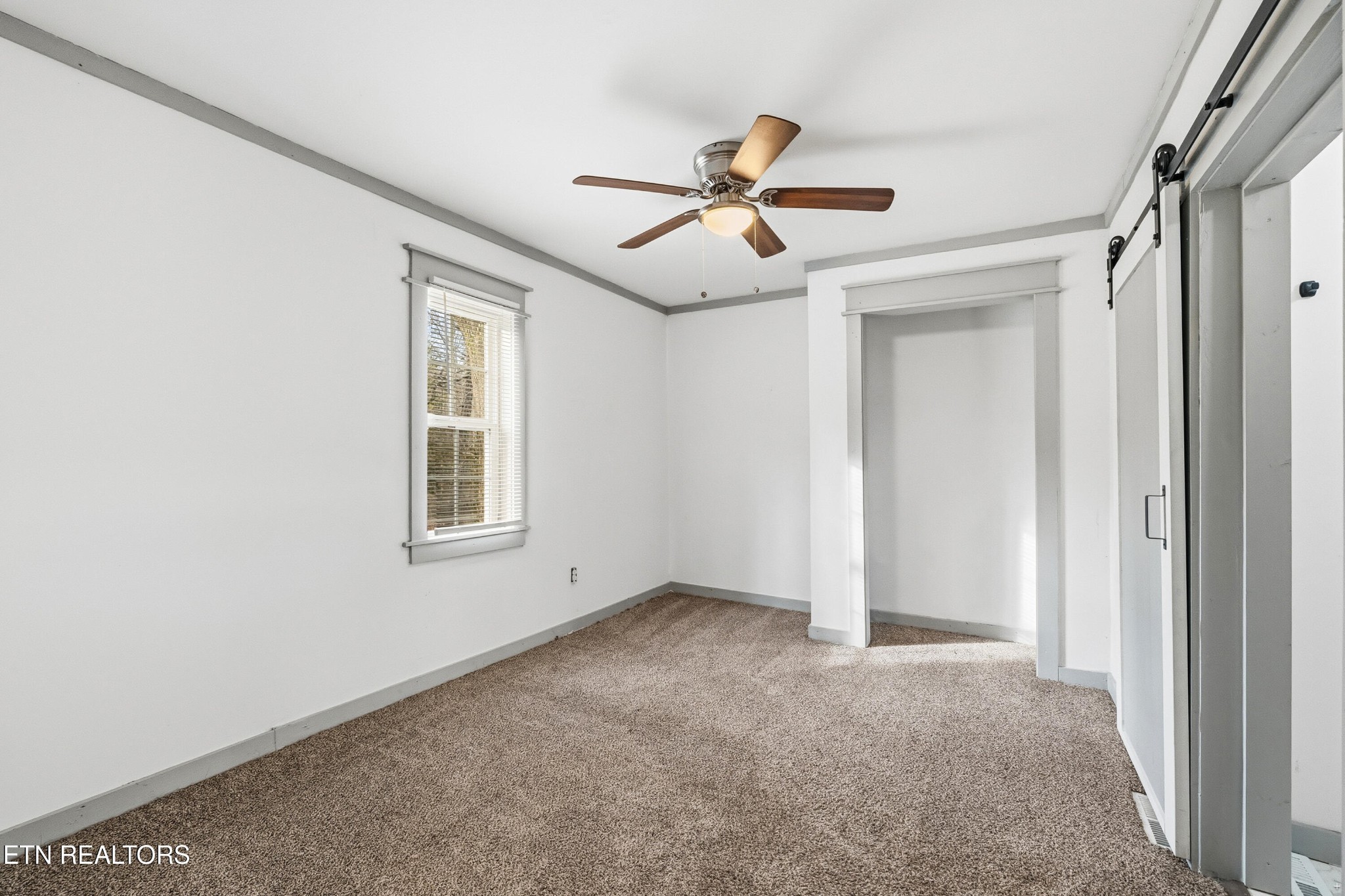 2438 Southside Road Knoxville, TN 37920 - Photo 13 of 21 an empty room with windows and fan